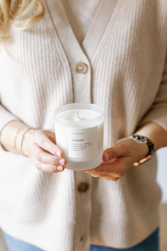 Picture of a person holding the Cheer Candle with the lid open