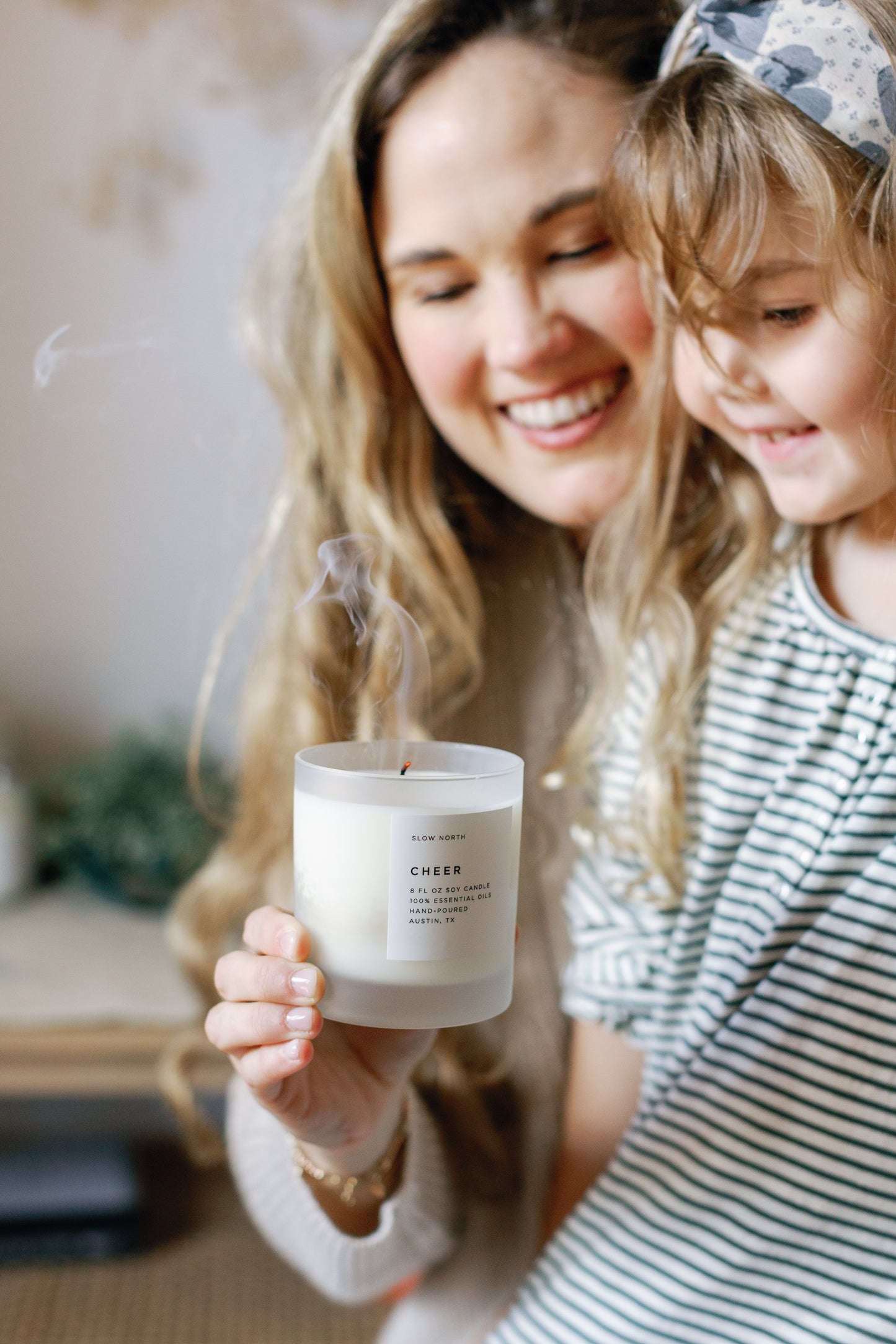 Image of a child smiling watching the Cheer Candle that has just been blown out