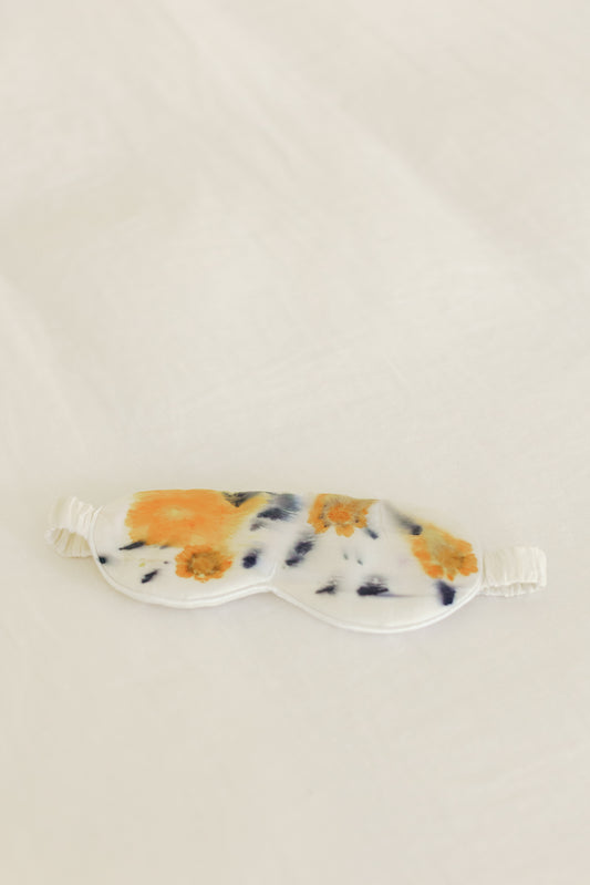 Image of the Floral Botanically Dyed Silk Sleep Mask on a table