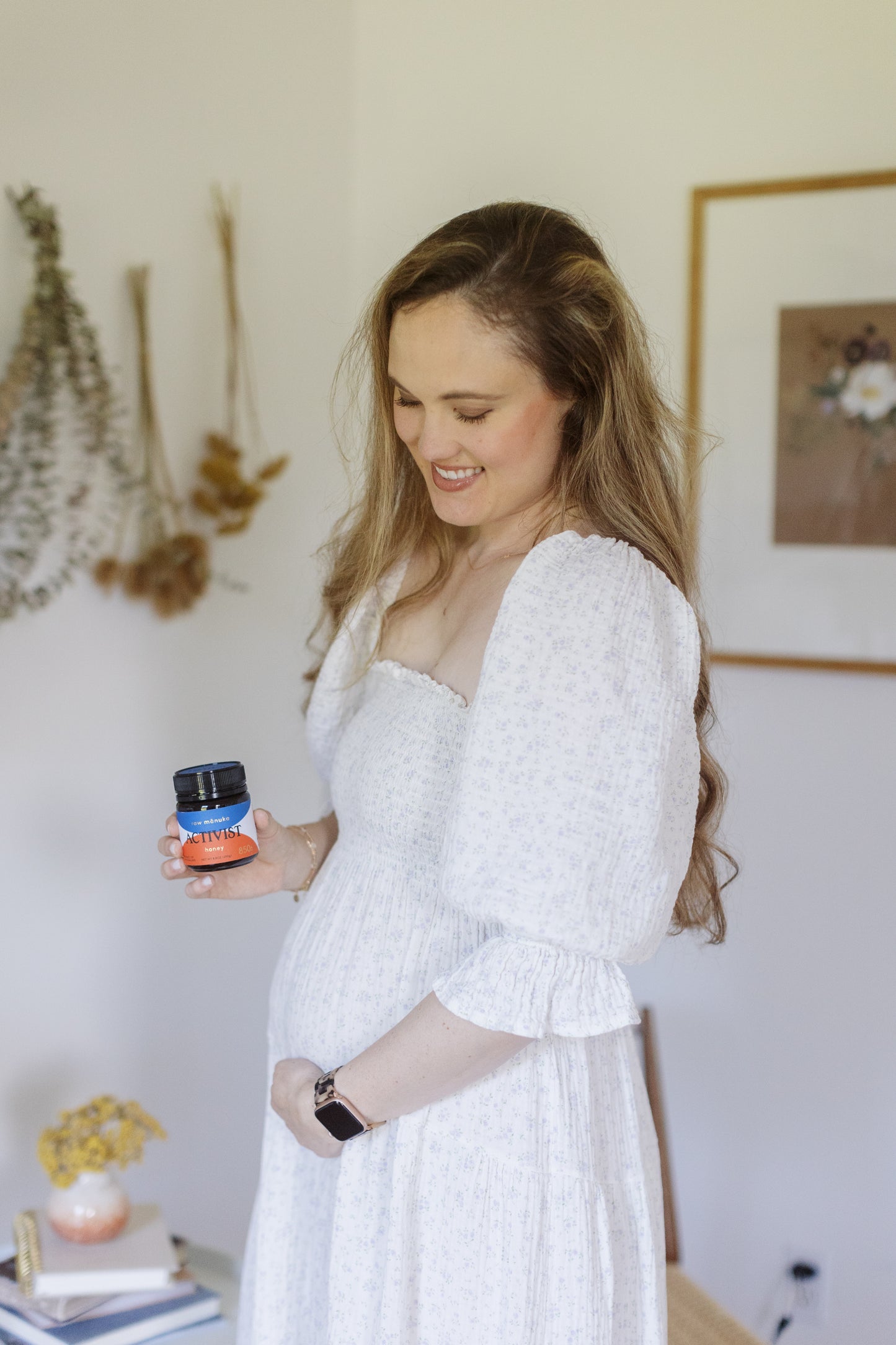 Caroline holding a jar of Mānuka Honey by Activist.