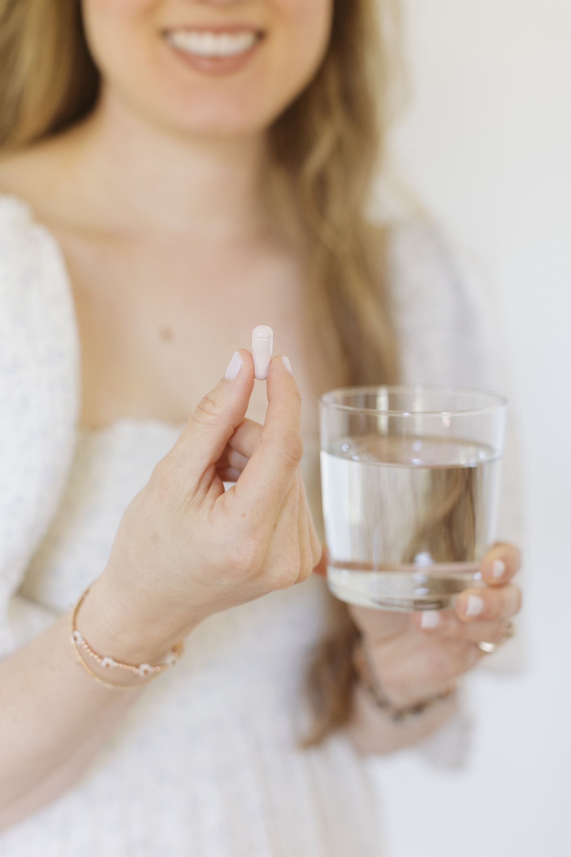 Caroline holding a Pure Radiance Vitamin C pill by Pure Synergy
