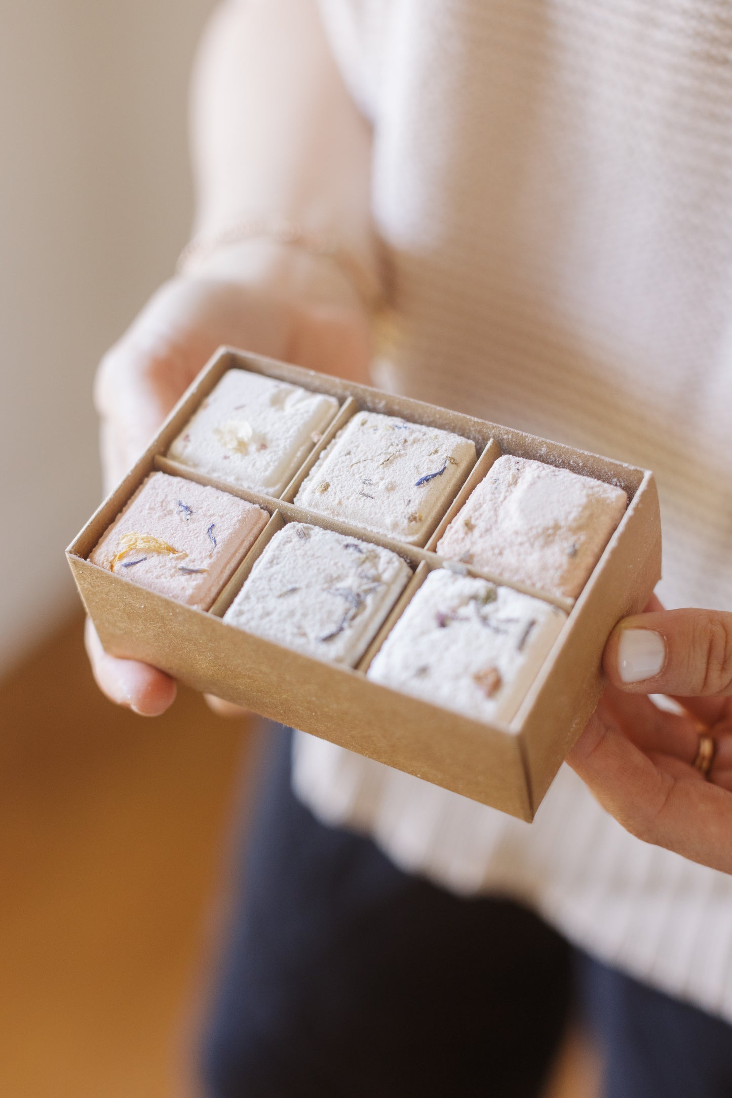 Picture of a hand holding the Bath Fizz Set open box