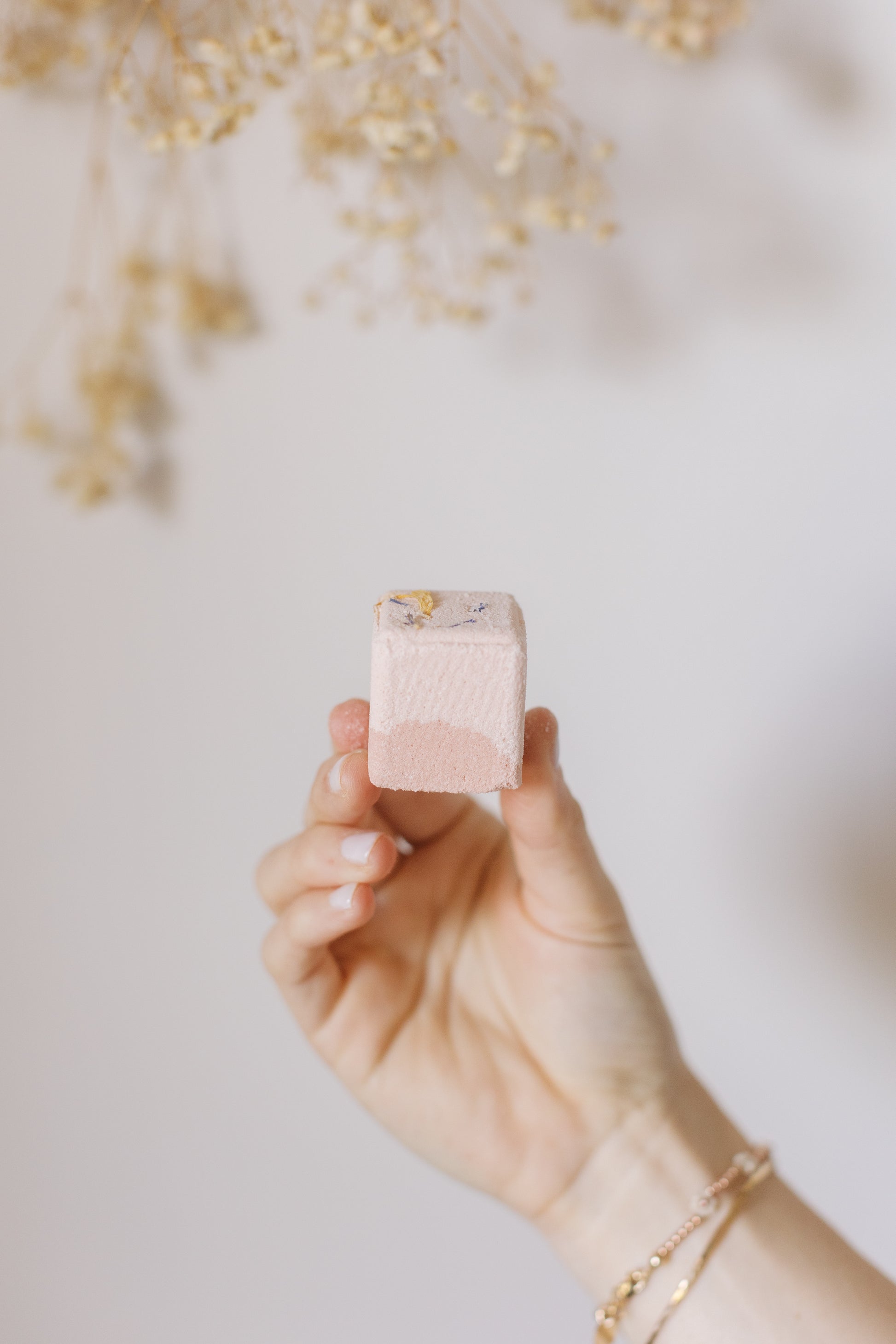 Picture of a hand holding one piece of the Bath Fizz Set