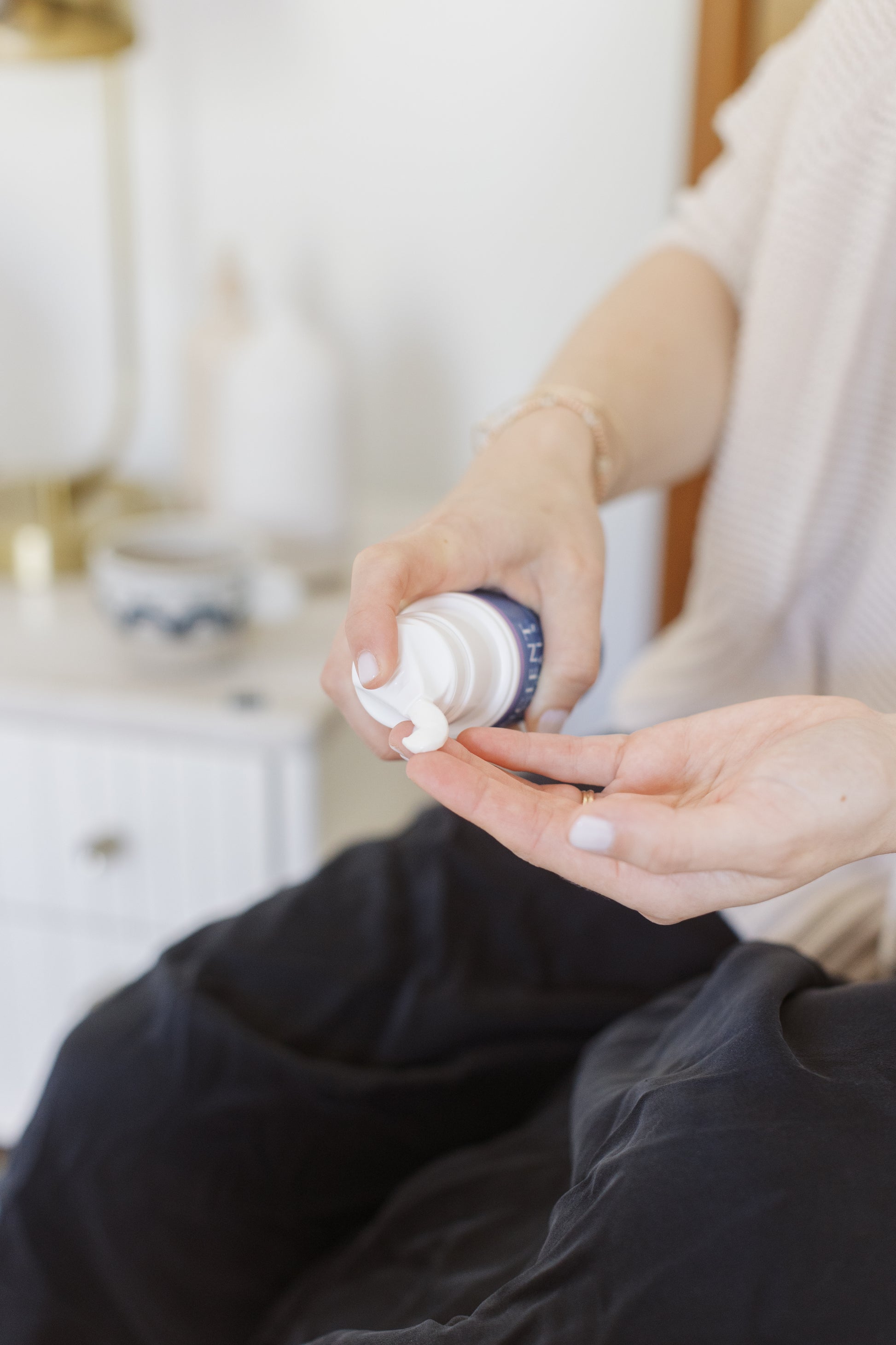 picture of a person using a bootle of the magnesium lotion goodnight on a hand