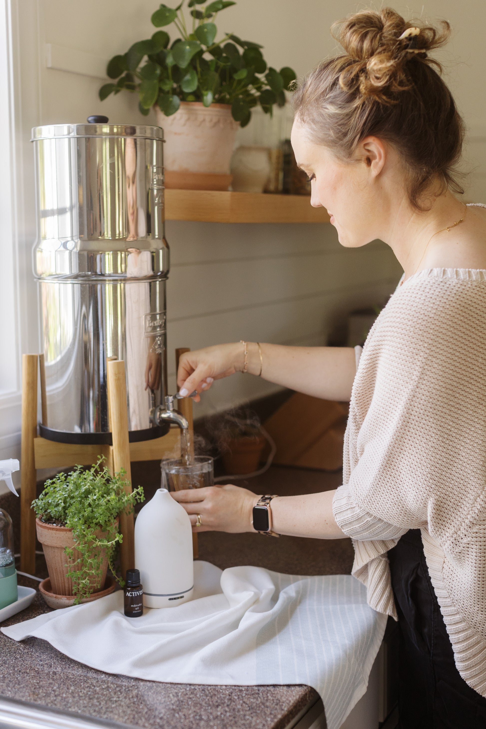Activist Manuka Essential Oil Sitting on a Counter Next to a Diffuser
