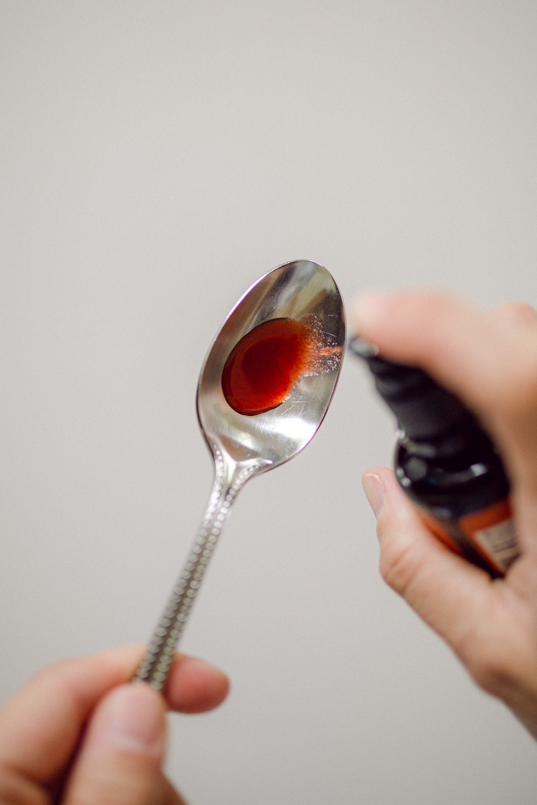 A few drops of Cymbiotika's Vitamin B12 + B6 on a spoon
