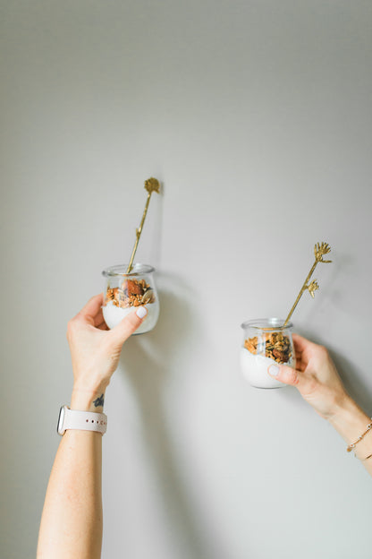 Two small yogurt bowls with Almond Butter + Chocolate Chunk Granola