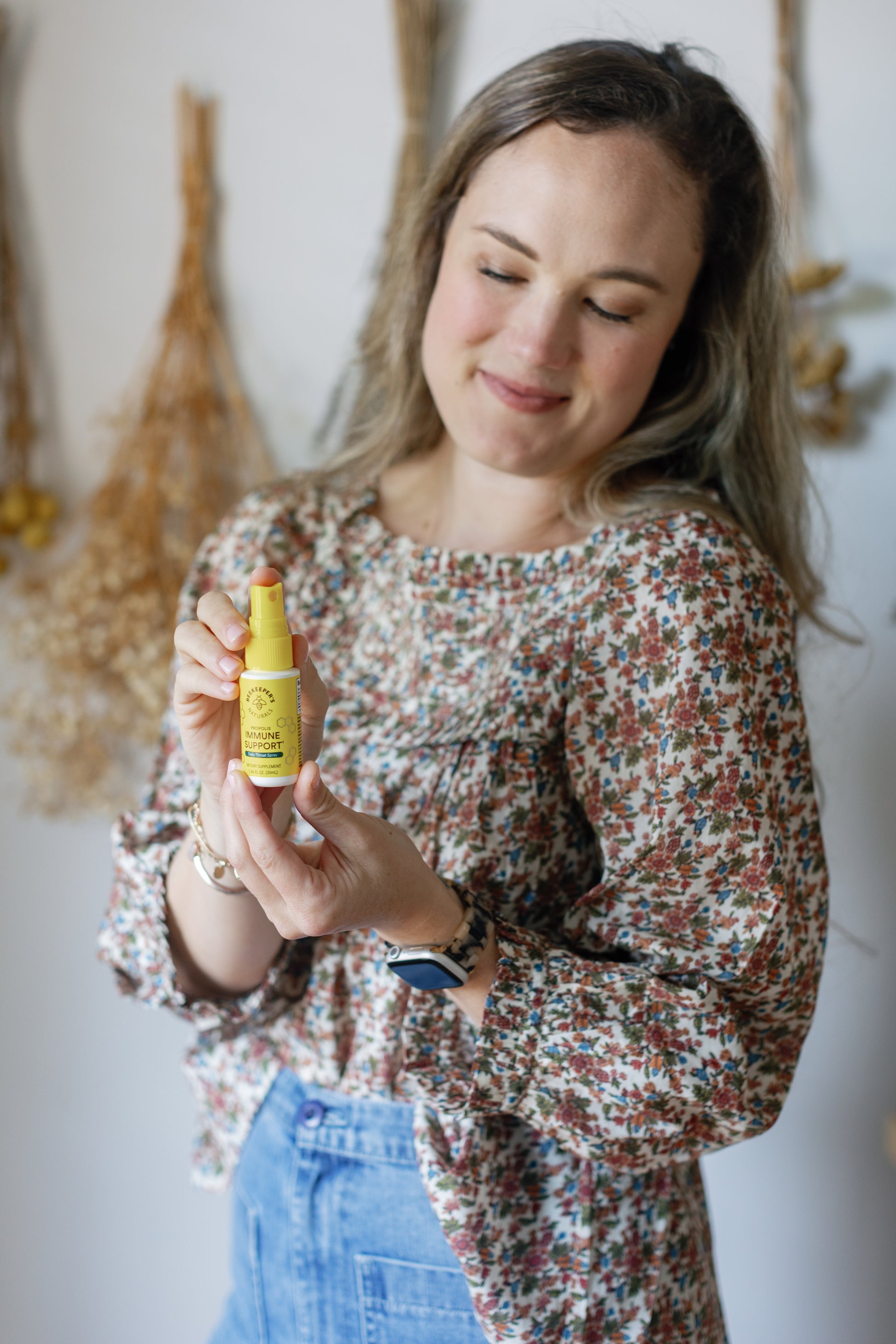 Image of Caroline smiling and showing the Propolis Throat Spray