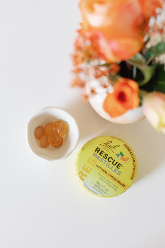 Picture of a woman holding in her hand a Bach Flower Rescue Stress Pastille