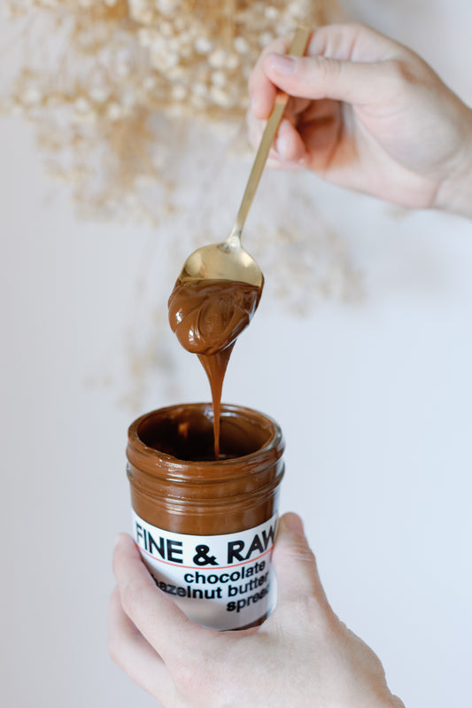 Image of the Chocolate Hazelnut Butter Spread open can with a spoon on top of it