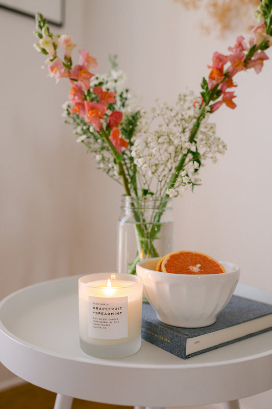 Image of a lit Grapefruit + Spearmint candle