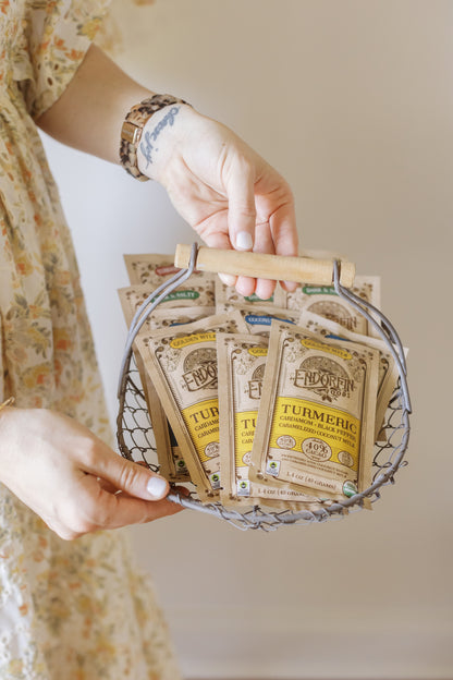 Image of a person holding a basket full of Golden Mylk Chocolate sachets