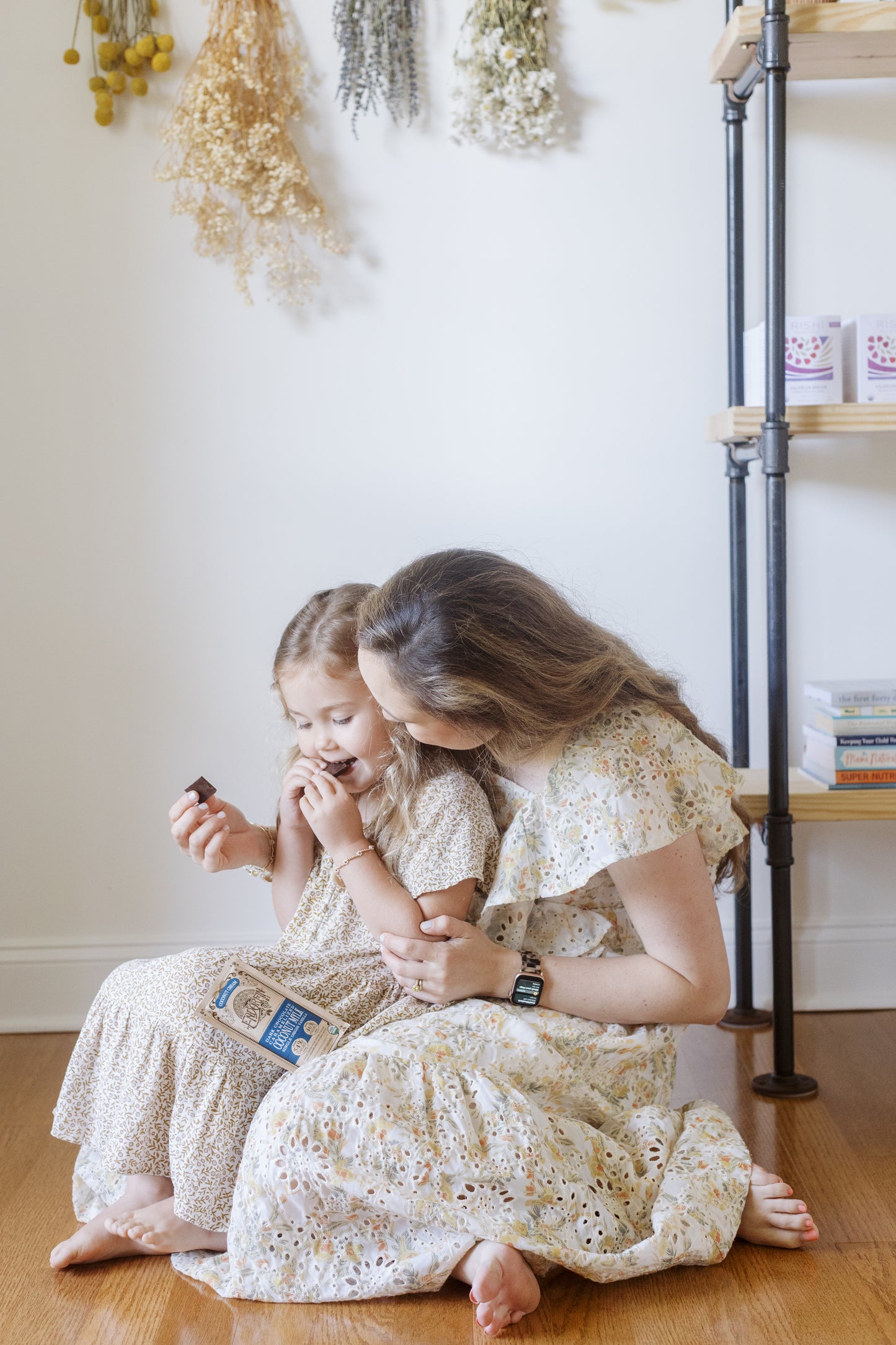 Image of a woman and her daughter smiling at each other while eating the Coconut Cream Chocolate