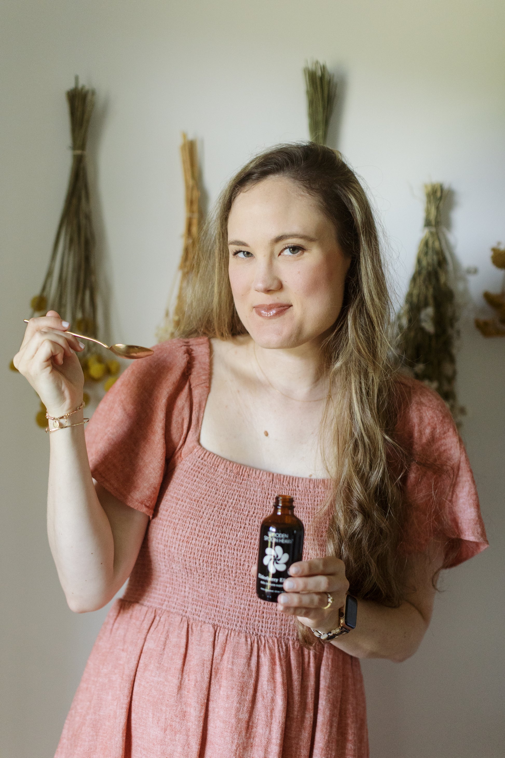 Caroline taste testing the Elderberry Elixir by Wooden Spoon Herbs