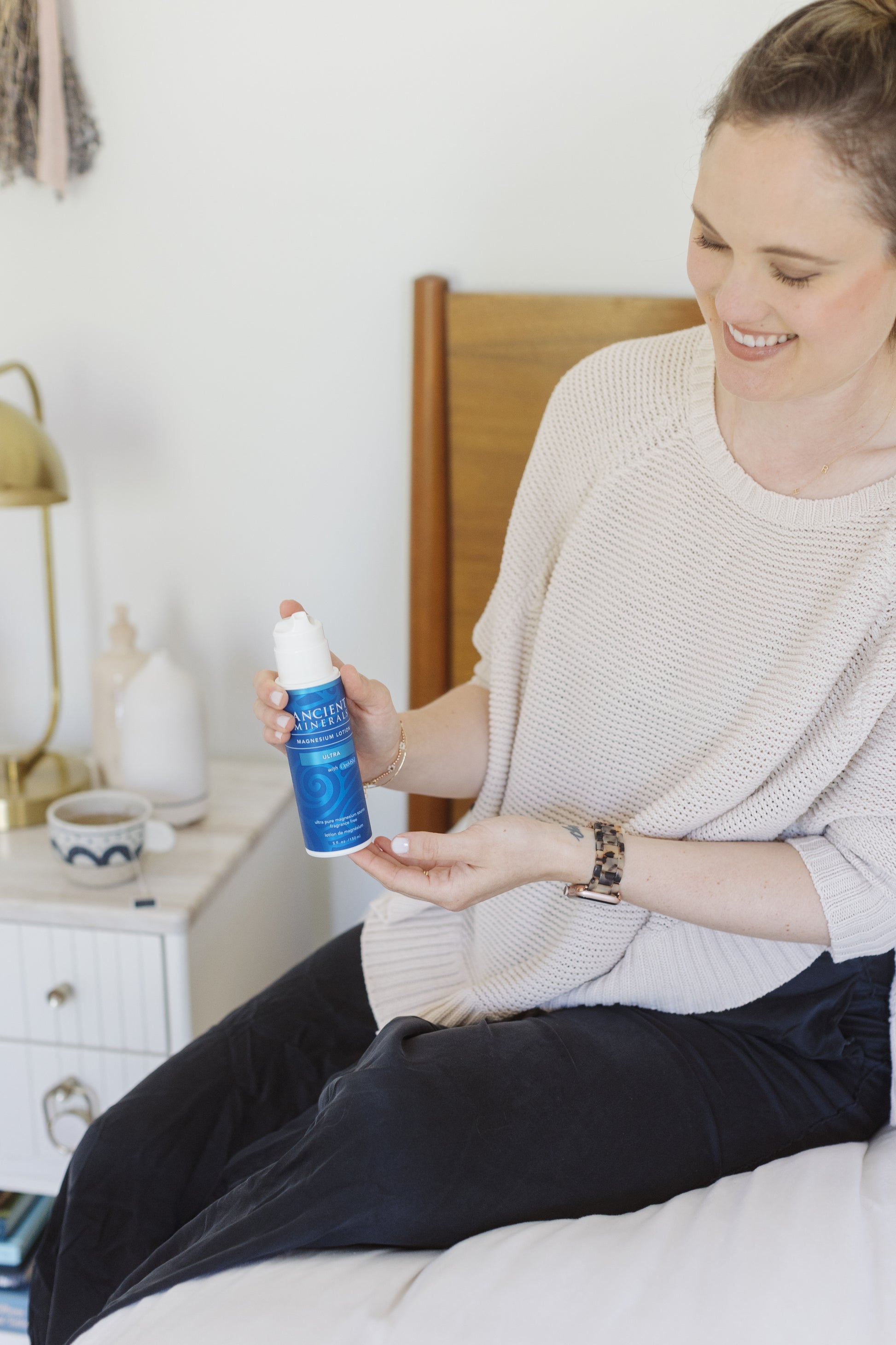 picture of a woman showing the magnesium lotion with MSM