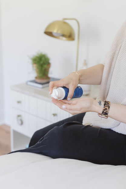 picture of a woman showing the magnesium lotion with MSM and using it on her hand